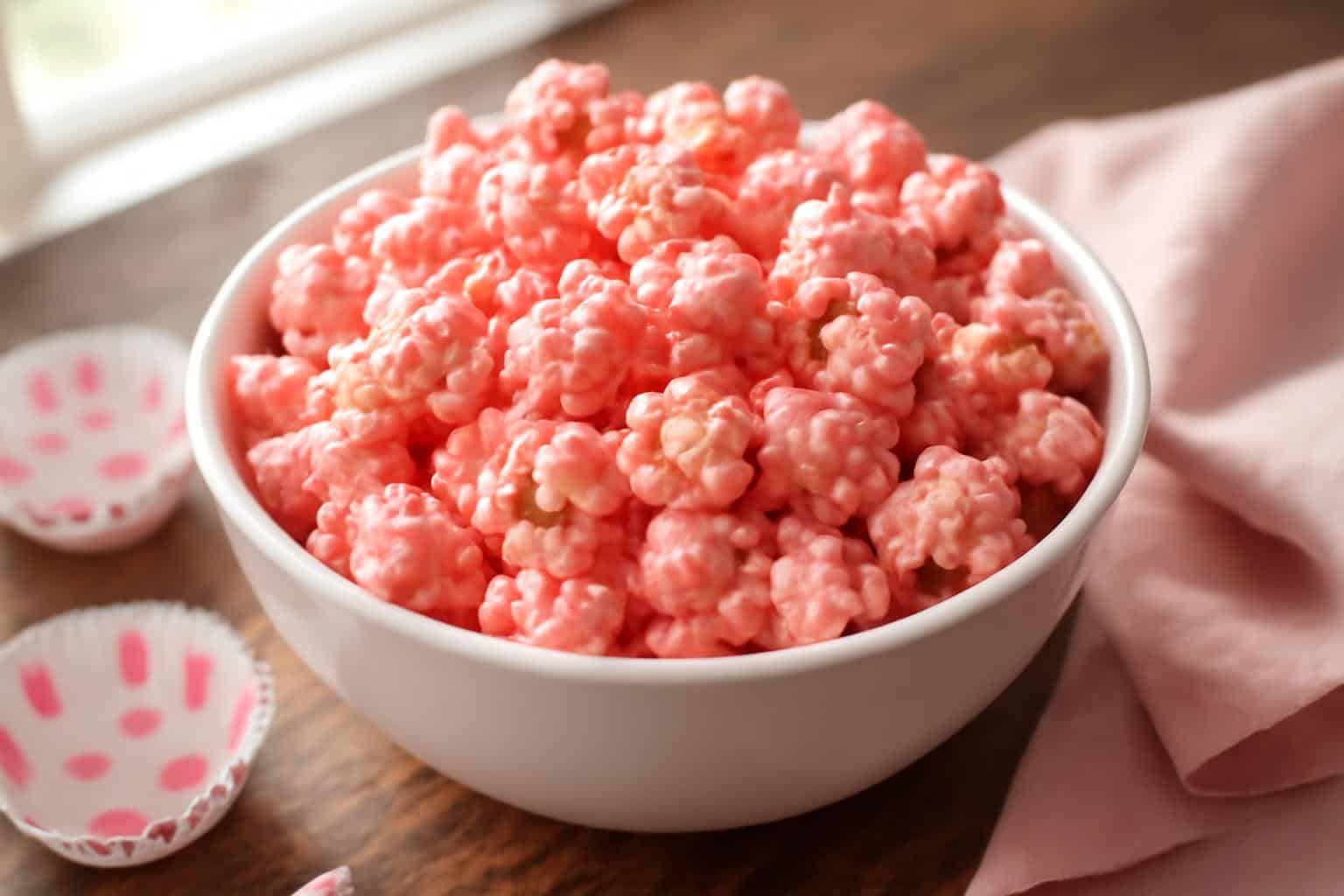 Bowl of sweetheart pink popcorn glazed in pink candy coating, perfect pink popcorn treat for Valentine’s Day