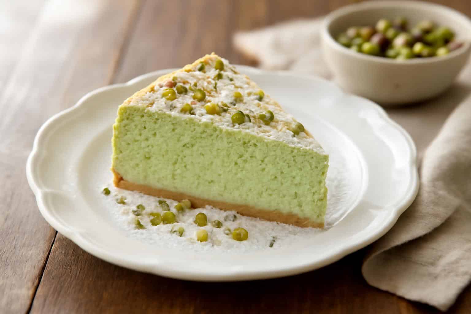 Slice of gâteau nuage pistache with crushed pistachio garnish on white plate